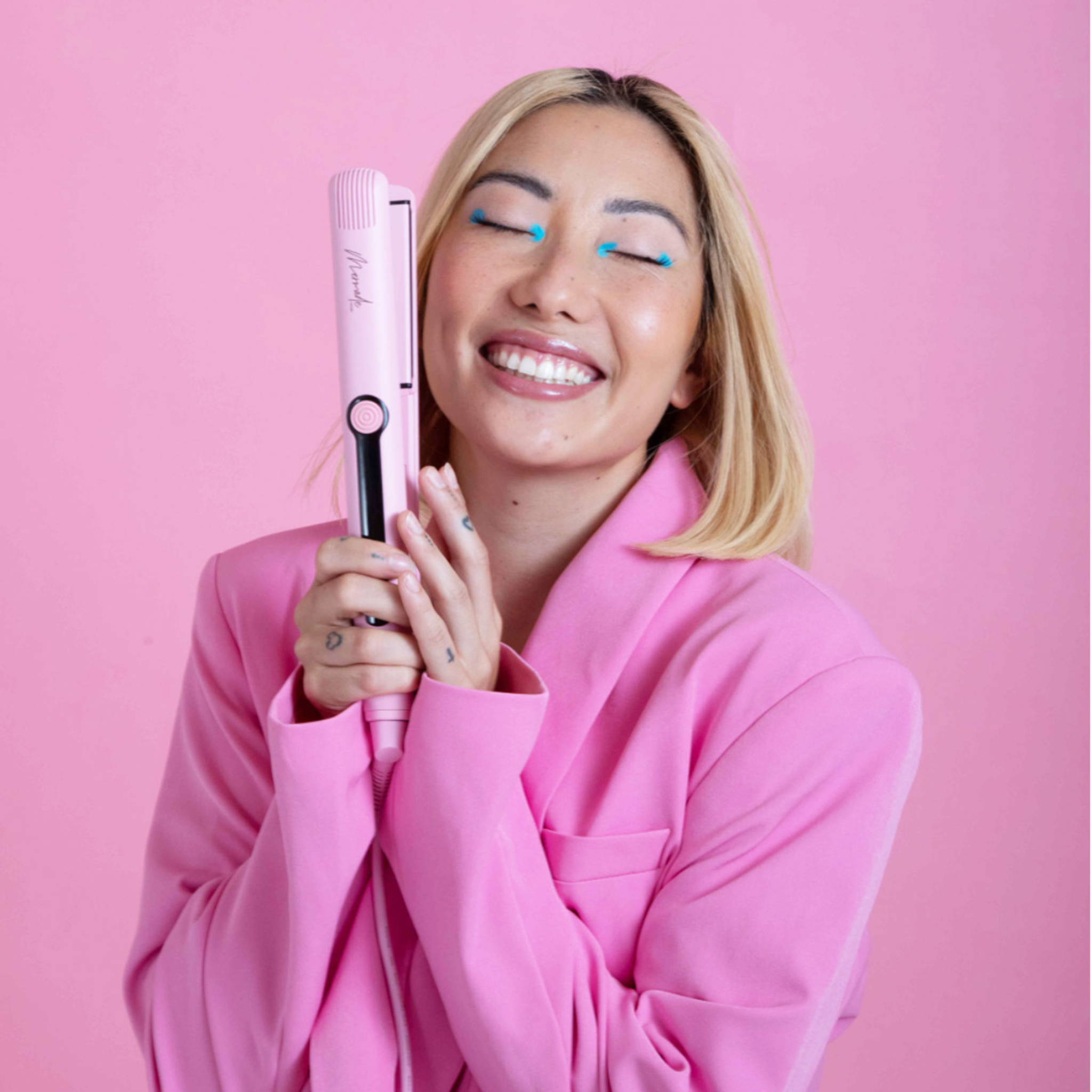 Model using the Mermade Hair Pink Straightener