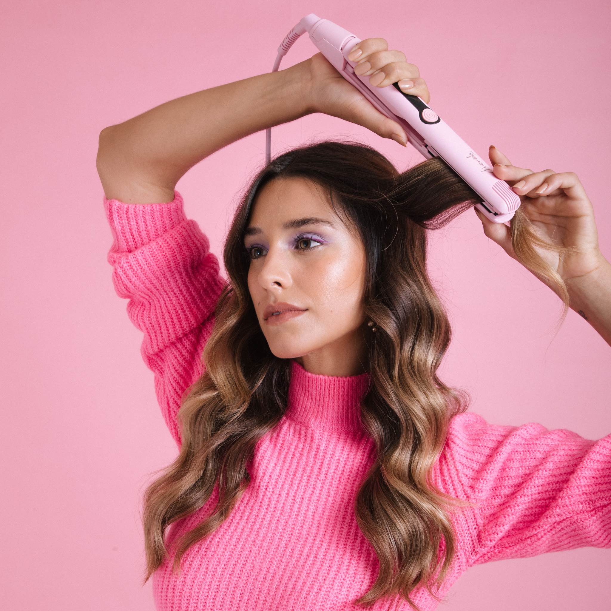 Model using the Mermade Hair Pink Straightener