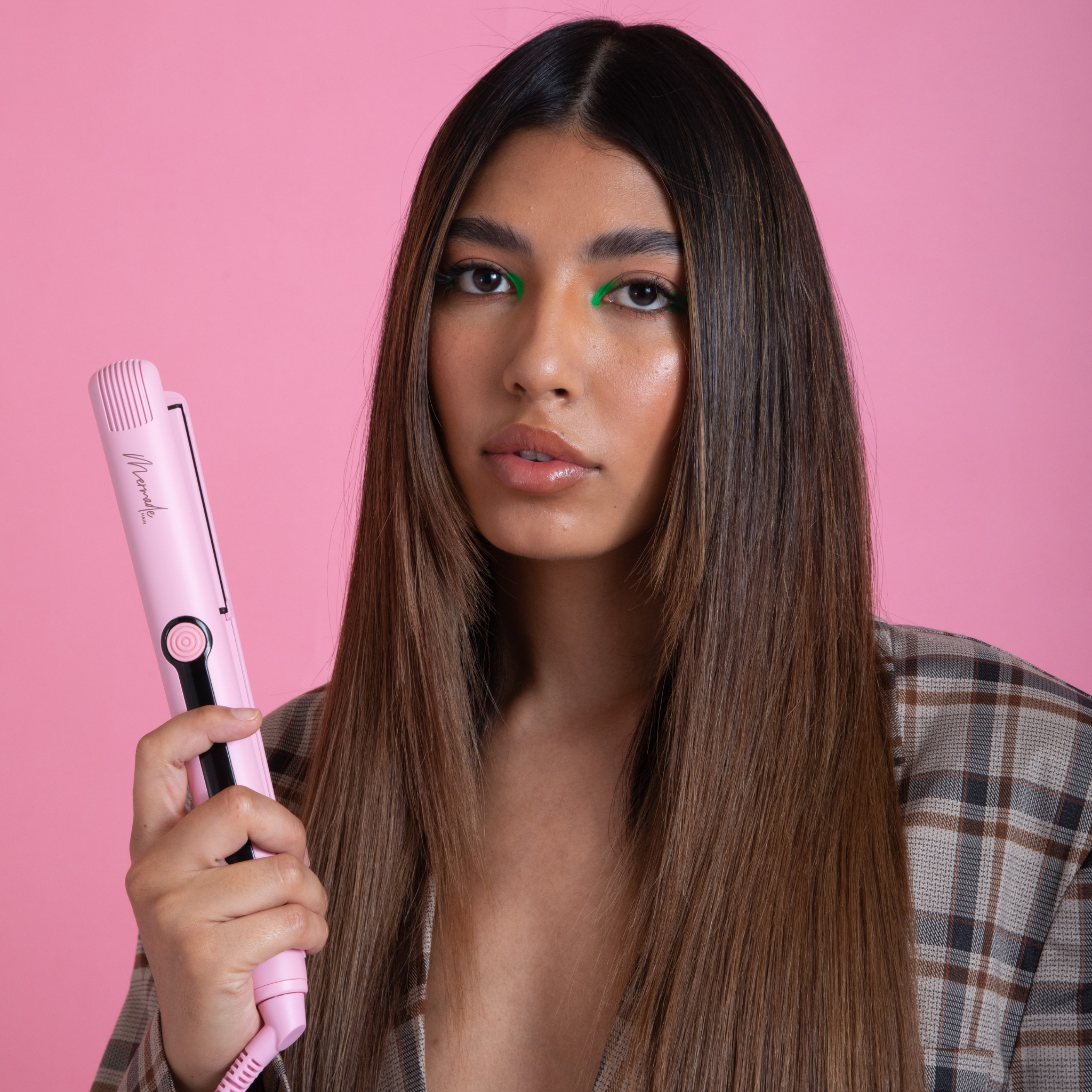 Model using the Mermade Hair Pink Straightener