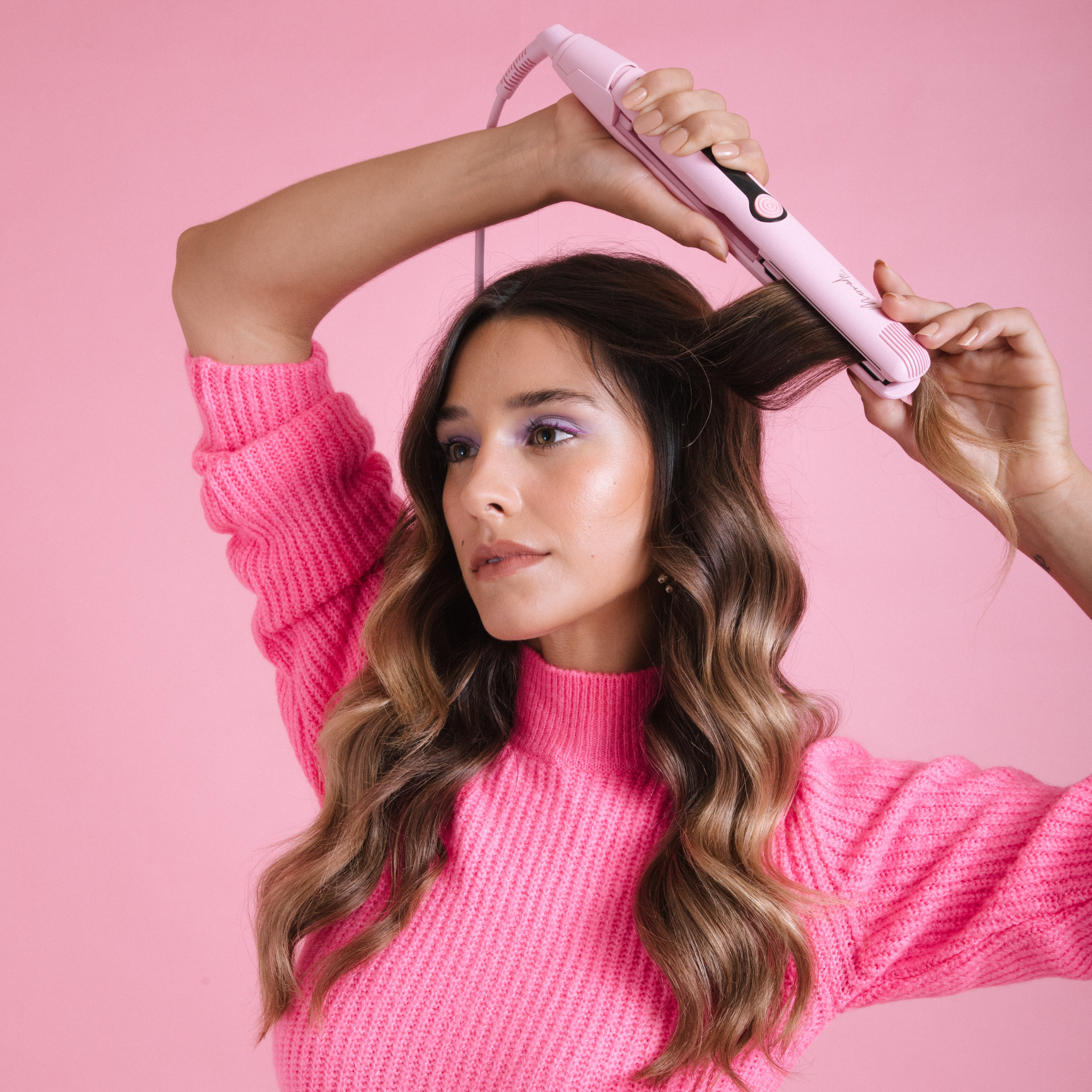 Model using the Mermade Hair Pink Straightener 