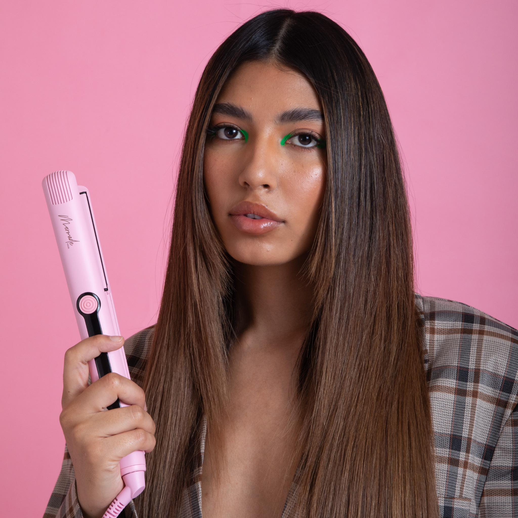 Model using the Mermade Hair Pink Straightener 