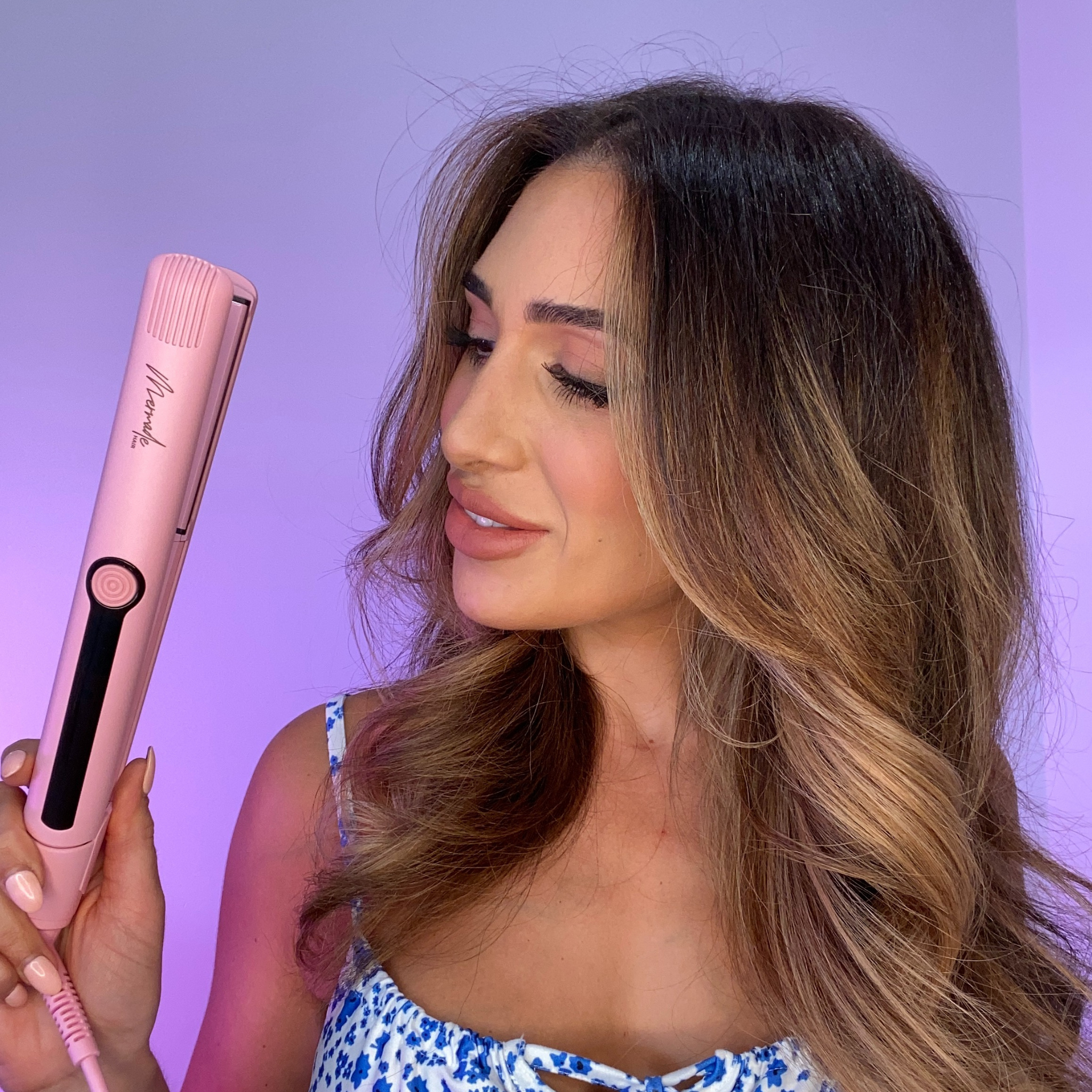 Model using the Mermade Hair Pink Straightener 